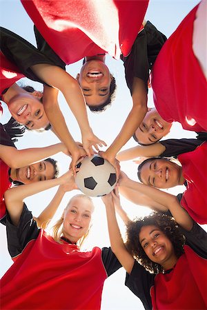 Directly below shot of female soccer team with ball forming huddle against clear sky Stock Photo - Budget Royalty-Free & Subscription, Code: 400-07336010