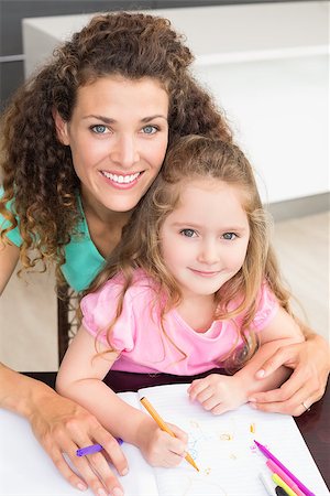 Smiling mother and daughter colouring together at the table at home in kitchen Stock Photo - Budget Royalty-Free & Subscription, Code: 400-07336254