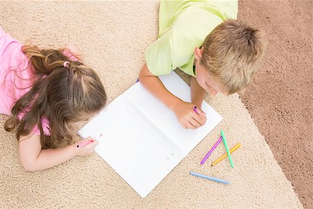 simsearch:6109-07601494,k - Siblings colouring on the rug at home in living room Stock Photo - Budget Royalty-Free & Subscription, Code: 400-07336300