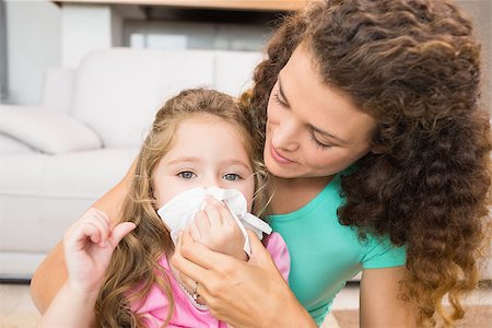 simsearch:400-06801081,k - Mother helping her daughter blow her nose at home in living room Photographie de stock - Aubaine LD & Abonnement, Code: 400-07336321