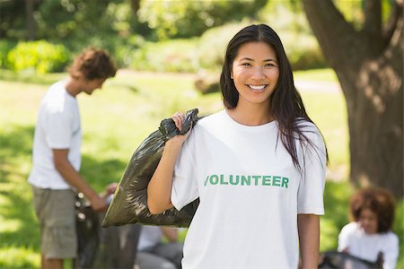 Team of young volunteers picking up litter in the park Stock Photo - Budget Royalty-Free & Subscription, Code: 400-07336723