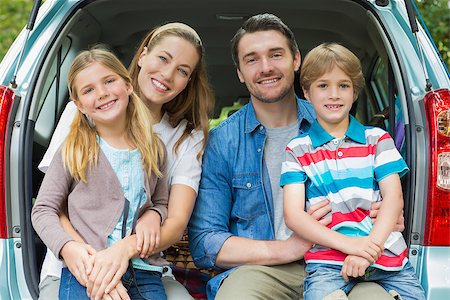 Portrait of a happy family of four sitting in car trunk while on picnic Stock Photo - Budget Royalty-Free & Subscription, Code: 400-07336858