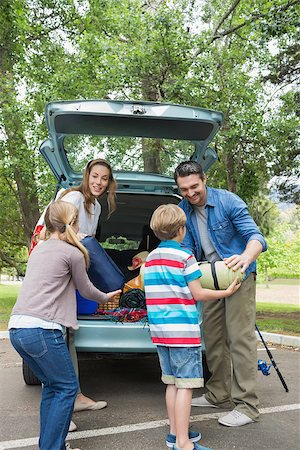 family loading car - Happy family of four unloading car trunk while on picnic Stock Photo - Budget Royalty-Free & Subscription, Code: 400-07336853