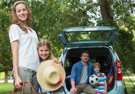 Portrait of mother and daughter with father and son sitting in car trunk Stock Photo - Budget Royalty-Free & Subscription, Code: 400-07336869
