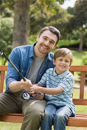 portrait of family on park bench - Portrait of a smiling father and son fishing while sitting on park bench Stock Photo - Budget Royalty-Free & Subscription, Code: 400-07336939