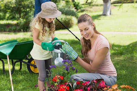 family watering lawn - Mother with daughter watering plants at the garden Stock Photo - Budget Royalty-Free & Subscription, Code: 400-07336953