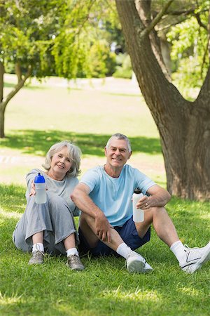 Portrait of a smiling mature couple sitting with water bottles at the park Stock Photo - Budget Royalty-Free & Subscription, Code: 400-07337058