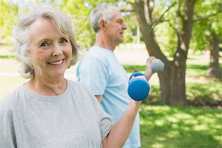 fitness   mature woman - Portrait of a mature couple using dumbbells at the park Stock Photo - Budget Royalty-Free & Subscription, Code: 400-07337075