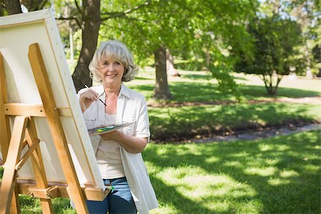 simsearch:400-04328345,k - Portrait of a smiling mature woman painting on canvas in the park Stock Photo - Budget Royalty-Free & Subscription, Code: 400-07337089