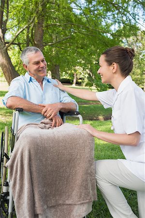 simsearch:400-07337135,k - Woman with her mature father sitting in wheel chair at the park Stock Photo - Budget Royalty-Free & Subscription, Code: 400-07337128