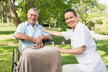 simsearch:400-07337135,k - Woman with her mature father sitting in wheel chair at the park Stock Photo - Budget Royalty-Free & Subscription, Code: 400-07337129