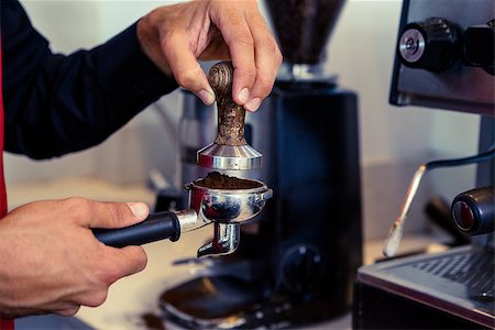 portafilter - Barista pressing fresh coffee grounds in a cafe Stock Photo - Budget Royalty-Free & Subscription, Code: 400-07337213
