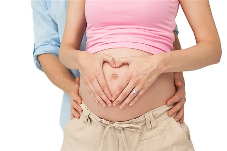 simsearch:400-06690931,k - Expectant parents embracing on white background Fotografie stock - Microstock e Abbonamento, Codice: 400-07337384