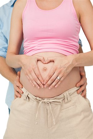 simsearch:400-06690931,k - Expectant parents hugging on white background Fotografie stock - Microstock e Abbonamento, Codice: 400-07337385