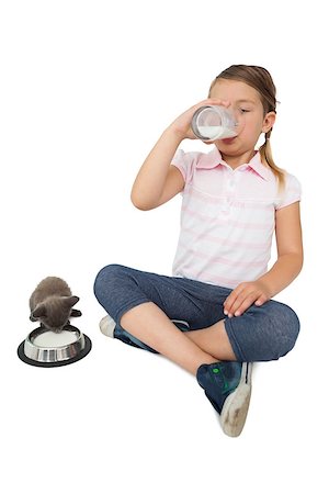 Cute little girl and grey kitten both drinking milk on white background Stock Photo - Budget Royalty-Free & Subscription, Code: 400-07337525