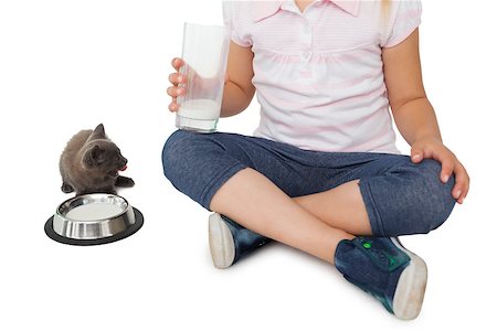 Cute girl and grey kitten both having milk on white background Stock Photo - Budget Royalty-Free & Subscription, Code: 400-07337527