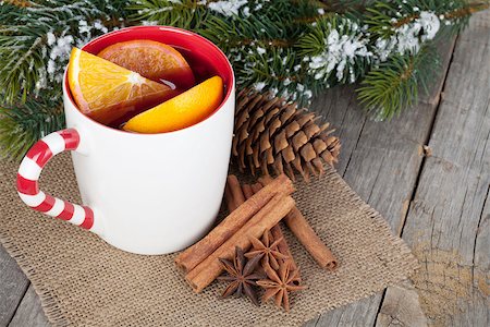 Christmas mulled wine with spices and snowy fir tree on wooden table Stock Photo - Budget Royalty-Free & Subscription, Code: 400-07337801