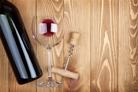 simsearch:400-07933837,k - Red wine bottle glass and corkscrew on wooden table with copyspace Stockbilder - Microstock & Abonnement, Bildnummer: 400-07337844