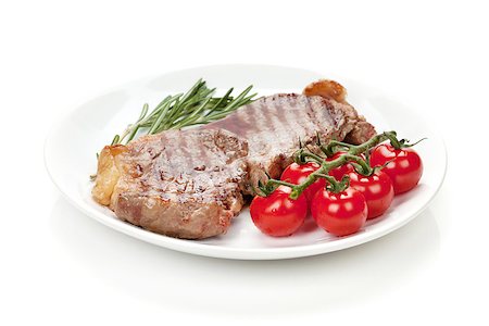 simsearch:695-05773485,k - Sirloin steak with rosemary and cherry tomatoes on a plate. Isolated on white background Foto de stock - Royalty-Free Super Valor e Assinatura, Número: 400-07337849