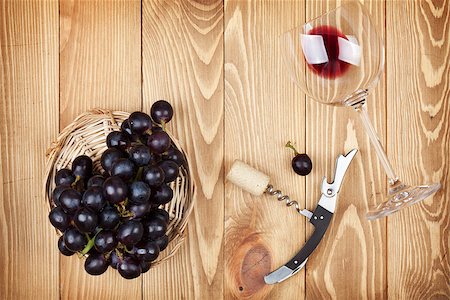 simsearch:400-07933837,k - Red wine glass, corkscrew and grape on wooden table background Stockbilder - Microstock & Abonnement, Bildnummer: 400-07337842