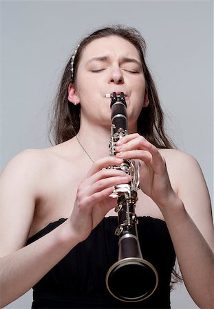 simsearch:400-07338880,k - Portrait of Young Female Musician Playing Clarinet Stock Photo - Budget Royalty-Free & Subscription, Code: 400-07338876