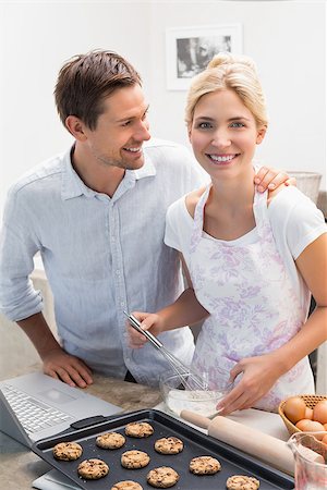 Portrait of a happy young couple preparing cookies in the kitchen at home Stock Photo - Budget Royalty-Free & Subscription, Code: 400-07339057