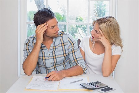 Worried young couple with financial documents and calculator sitting at home Stock Photo - Budget Royalty-Free & Subscription, Code: 400-07339117