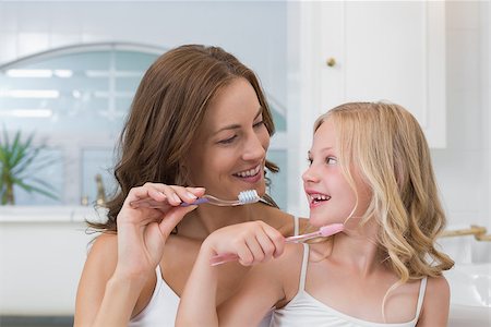 Close-up of mother and daughter brushing teeth in the bathroom Stock Photo - Budget Royalty-Free & Subscription, Code: 400-07339467