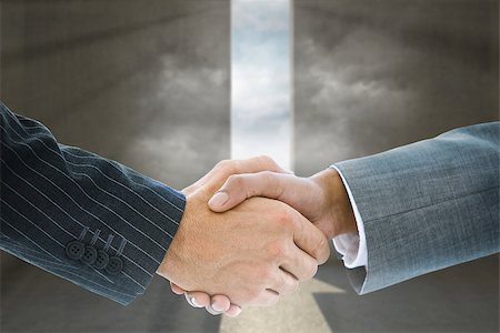 simsearch:400-07339684,k - Composite image of business handshake against arrow door in dark room Stock Photo - Budget Royalty-Free & Subscription, Code: 400-07339600