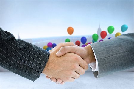 simsearch:400-07339684,k - Composite image of business handshake against balloons in a room Stock Photo - Budget Royalty-Free & Subscription, Code: 400-07339620