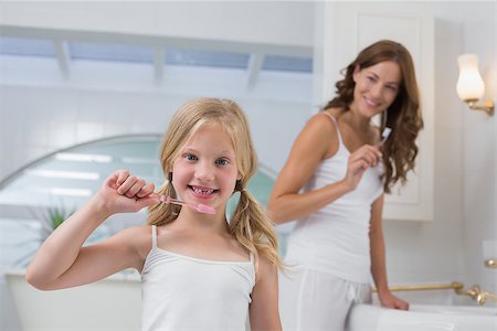 Portrait of a little girl with mother brushing teeth in the bathroom Stock Photo - Budget Royalty-Free & Subscription, Code: 400-07339642