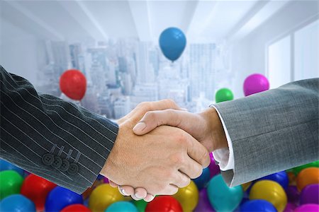 simsearch:400-07339684,k - Composite image of business handshake against balloons in a room Stock Photo - Budget Royalty-Free & Subscription, Code: 400-07339679
