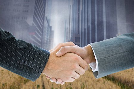 simsearch:400-07339684,k - Composite image of business handshake against cityscape projection over yellow fields Stock Photo - Budget Royalty-Free & Subscription, Code: 400-07339696