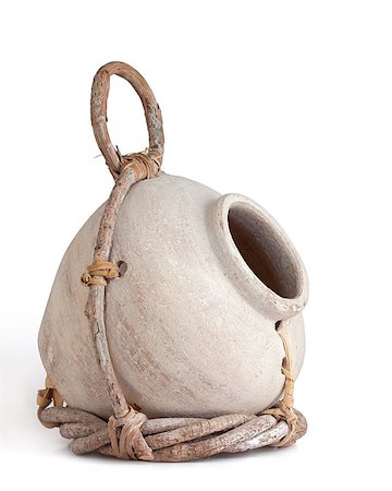 pot holder - Cream colored birdhouse jug partially wrapped in a twig holder held together with leather straps. white background, angular view. Stock Photo - Budget Royalty-Free & Subscription, Code: 400-07330029