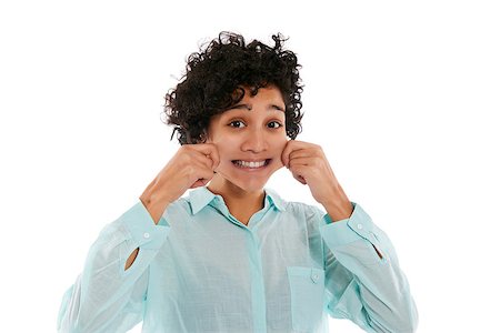 hispanic woman doing facial expression, giving herself a pinch on cheek to smile while looking at camera on white background Stockbilder - Microstock & Abonnement, Bildnummer: 400-07330336