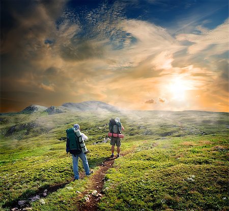 Backpackers on footpath in mountains at sunny day Stock Photo - Budget Royalty-Free & Subscription, Code: 400-07330331
