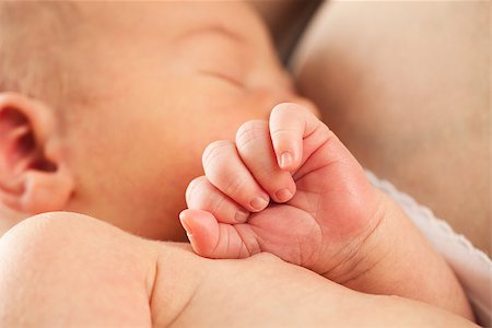 Newborn baby sleeping in mother's arm after breastfeeding Stock Photo - Budget Royalty-Free & Subscription, Code: 400-07330931