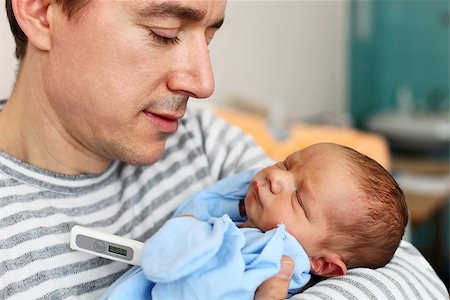 daddy sleeping with newborn baby - Father taking newborn son's temperature with thermometer Stock Photo - Budget Royalty-Free & Subscription, Code: 400-07330953