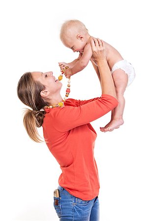 diapering mother to baby - Young Caucasian woman lifting her baby son over white, boy playing with nursing necklace Photographie de stock - Aubaine LD & Abonnement, Code: 400-07330968