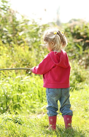 small babies in park - a beautiful little girl in nature playing with a stick Stock Photo - Budget Royalty-Free & Subscription, Code: 400-07331005