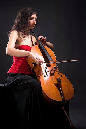 simsearch:400-07338880,k - Young Woman in Red Top Playing Violoncello Stock Photo - Budget Royalty-Free & Subscription, Code: 400-07331124