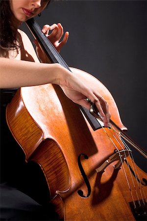 simsearch:400-07338880,k - Closeup of a Female Musician Playing Violoncello Stock Photo - Budget Royalty-Free & Subscription, Code: 400-07331125