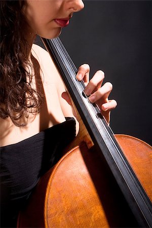 simsearch:400-07338880,k - Closeup of a Female Musician Playing Violoncello Stock Photo - Budget Royalty-Free & Subscription, Code: 400-07331129