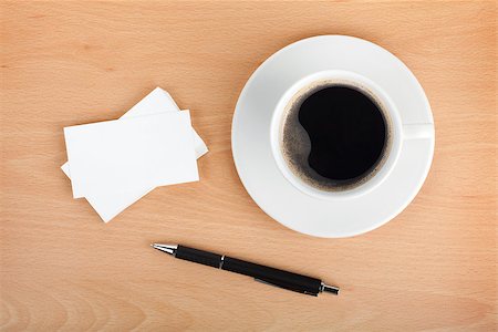 Blank business cards with coffee cup and pen on wooden office table Stock Photo - Budget Royalty-Free & Subscription, Code: 400-07331481