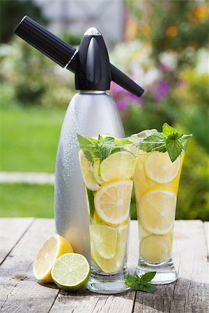simsearch:400-07324083,k - Homemade lemonade with fresh citruses and siphon on garden table Stock Photo - Budget Royalty-Free & Subscription, Code: 400-07331683
