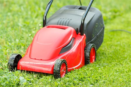 simsearch:400-05318999,k - new lawnmower on green grass in cloudy day Photographie de stock - Aubaine LD & Abonnement, Code: 400-07331952