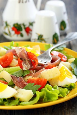 potato salad yellow - Plate with salad and fork on a wooden table. Stock Photo - Budget Royalty-Free & Subscription, Code: 400-07332364