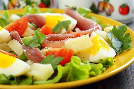 potato salad yellow - Salad with eggs, cherry tomatoes and anchovies on a yellow plate. Stock Photo - Budget Royalty-Free & Subscription, Code: 400-07332363