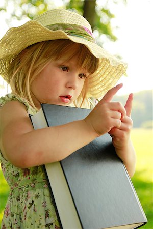 small babies in park - a beautiful little girl with the Book in nature Stock Photo - Budget Royalty-Free & Subscription, Code: 400-07332842
