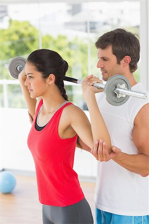 simsearch:400-06801591,k - Male trainer helping young fit woman to lift the barbell in the gym Stock Photo - Budget Royalty-Free & Subscription, Code: 400-07333067
